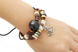 Retro multilayer leather bracelet with wooden beads and silver anchor charm on wrist
