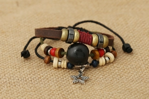 Close-up of bohemian leather bracelet featuring wooden beads and a starfish charm