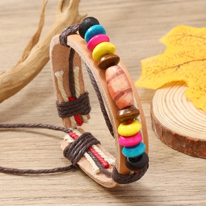 Detail of bohemian handmade leather bracelet with colorful wooden beads and cord