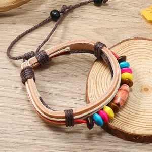 Handmade bohemian multilayer leather bracelet with colorful beads on a wooden background