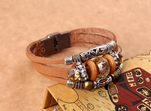 Dettaglio del bracciale multistrato in pelle con perline vintage e chiusura magnetica