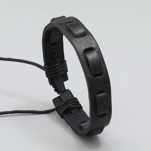 Macro detail of multi-layer black braided leather bracelet with high-quality matte texture