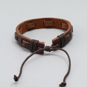Close-up of brown braided leather bracelet with adjustable drawstring closure detail