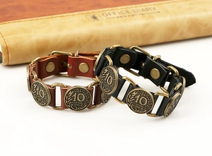 Detail of vintage leather bracelet with bronze rings and French coin charms