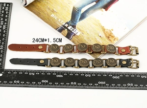 Detail view of vintage leather bracelets showing 24cm size and antique coin accents