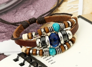 Macro shot of vintage multilayer leather bracelet with blue stone and turquoise beads