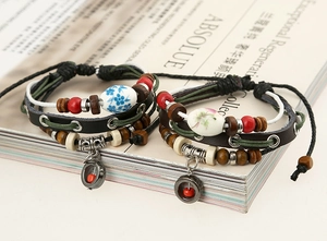 Close-up of bohemian multilayer leather bracelets with ceramic beads and wood accents