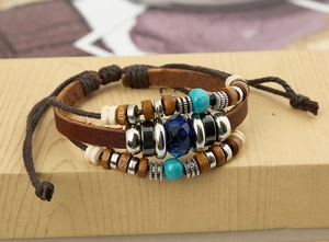 Detail of vintage multilayer leather bracelet with wooden beads and turquoise accents