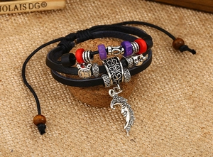 Macro detail of multilayer leather bracelet with moon pendant and colorful beaded accents