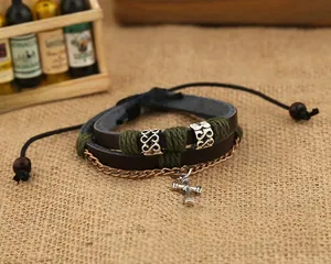 Macro shot of multilayer leather bracelet with silver cross charm and wooden beads