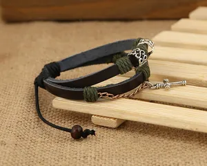Detail view of multi-layer leather bracelet with silver cross pendant and beads