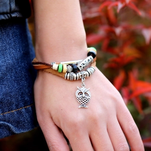 Bracciale multistrato in pelle con ciondolo a civetta e perline vintage su polso maschile