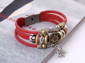 Close-up of red multi-layer leather bracelet with snowflake charm and magnetic buckle