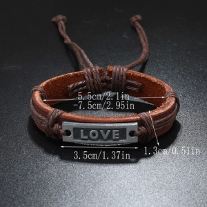 Vintage brown leather woven bracelet with adjustable sizing and metallic LOVE plate