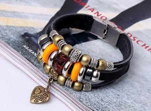 Detail of multi-layer leather bracelet with bronze beads, heart pendant, and magnetic clasp