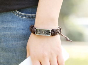 Detail of adjustable leather bracelet featuring a vintage Swedish warrior metal plate