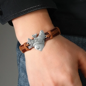 Vintage woven leather bracelet with silver tribal fish charm and adjustable strap