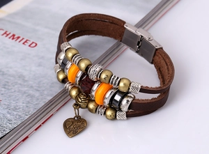 Detail of multi-layer leather bracelet featuring heart pendant and magnetic steel clasp