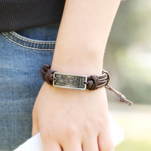 Vintage dark brown braided leather bracelet with silver Sweden metal plate on wrist