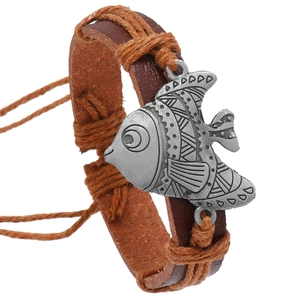 Vintage woven leather bracelet with fish charm and ethnic patterns on white background