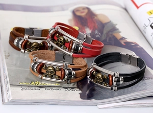 Detailed macro of multi-layer leather braided bracelets with retro bronze skull charms
