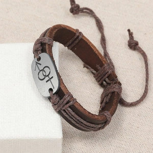 Vintage braided brown leather bracelet featuring a metal plaque with gender symbols