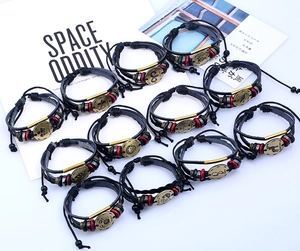 Detail view of 12 zodiac multi-layer leather bracelets with bronze alloy charms and beads