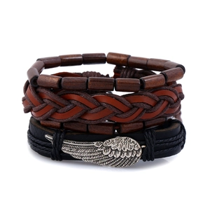 Detail of vintage men's multi-layer bracelet set with wooden beads and silver wings charm