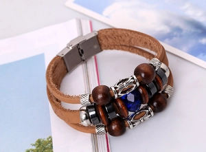 Macro view of multi-layer leather bracelet with blue gemstone and metallic clasp