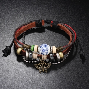 Detailed view of punk multi-layer leather bracelet with bronze butterfly and ceramic bead