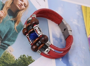 Detailed view of multilayer leather bracelet with blue gemstone and wooden beads