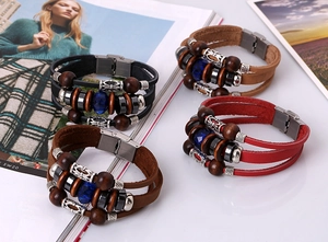 Detailed view of layered bohemian leather bracelets with beads and stainless steel clasp