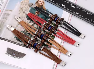 Detail of multi-layer braided leather bracelets with beads and metallic charms
