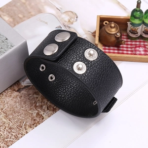 Detailed view of black litchi pattern leather bracelet with four silver metal snap buttons