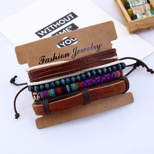 4-piece set of handmade ethnic leather bracelets with braided cords and beads on display card