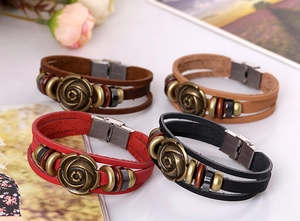Detail of retro leather bracelets with bronze rose charms and stainless steel clasps