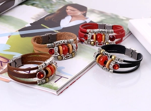 Detail of multilayer leather beaded bracelets with metallic magnetic clasps and crystals