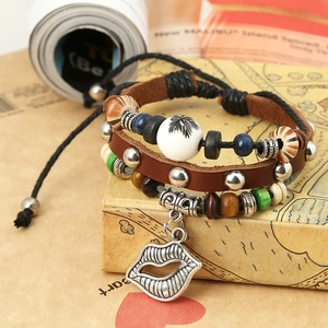 Multilayer leather bracelet with palm tree bead and hollow lip pendant in retro style