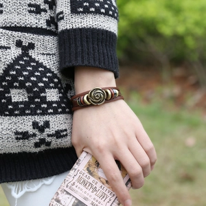 Vintage multilayer leather bracelet featuring an embossed bronze rose charm for women