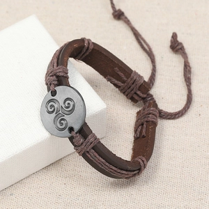Retro brown leather bracelet with triskele metal charm and adjustable woven rope detail