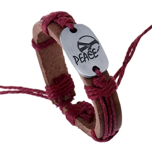 Punk style woven leather bracelet with peace sign metal plate on white background