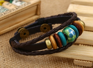 Detail of vintage braided leather bracelet with turquoise beads and antique metal clasp
