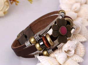 Macro view of multilayer leather bracelet with vintage bronze floral and bead accents