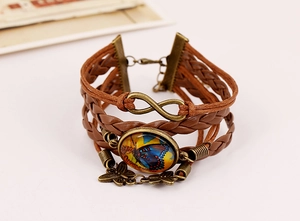 Macro detail of multilayer braided PU leather bracelet with infinity symbol and butterfly charm