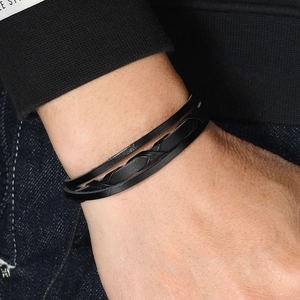 Minimalist multi-layer black braided leather bracelet for men and women on model wrist
