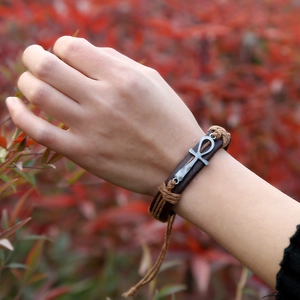 Handwoven vintage brown leather bracelet with silver Ankh symbol shown on male wrist