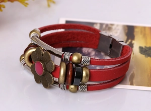 Macro shot of red multilayer leather bracelet with bronze flower slider and beads