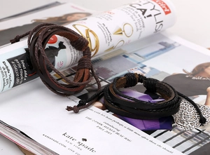 Detail of multi-layer braided leather bracelets with handcrafted knot and retro finish