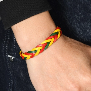 Handmade braided leather bracelet in red, yellow, and green flag colors with adjustable fit