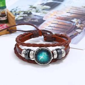Close-up of Sagittarius zodiac sign on retro layered brown braided leather bracelet